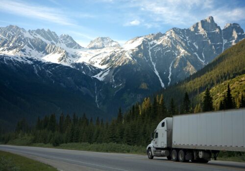 semi truck on road with mountains in background
