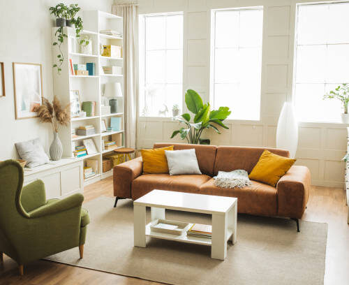 istockphoto-1421422160-612x612 Sofa and armchair in living room. Interior of simple home. Furniture is arranged in sitting area.